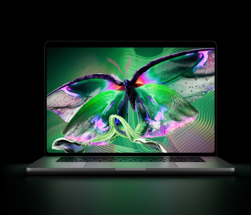 MacBook Pro avec Écran PROLED XDR, ouvert, argent, l’écran affiche une image détaillée au contraste élevé avec des couleurs éclatantes, l’écran illumine le clavier